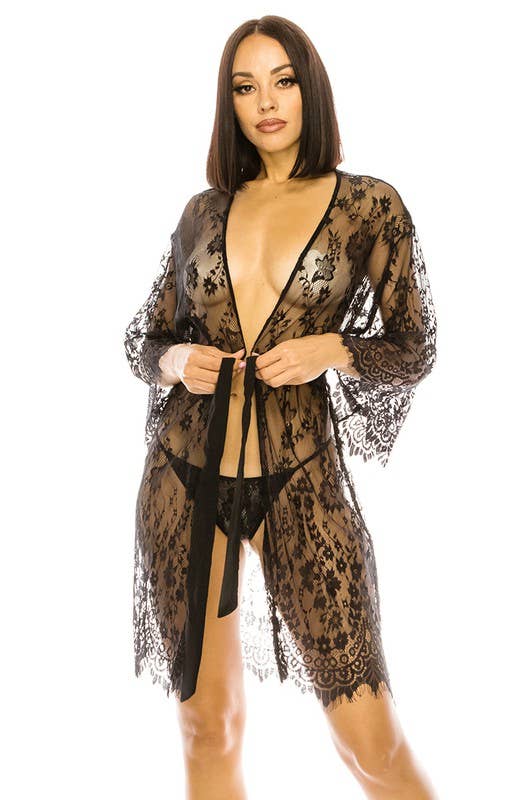 Woman wearing a black lace lingerie set on a white background